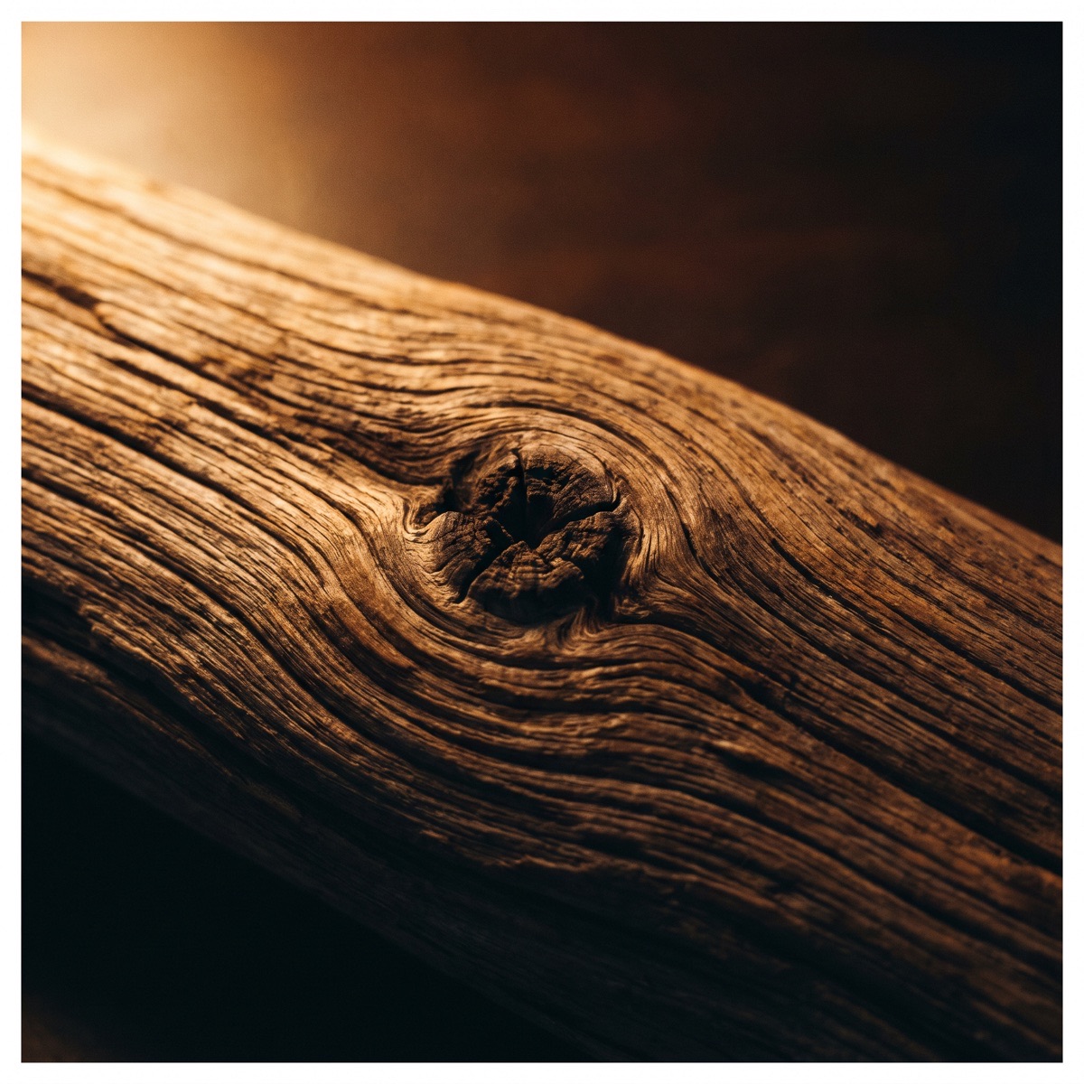 Weathered wood grain flowing around a single knot